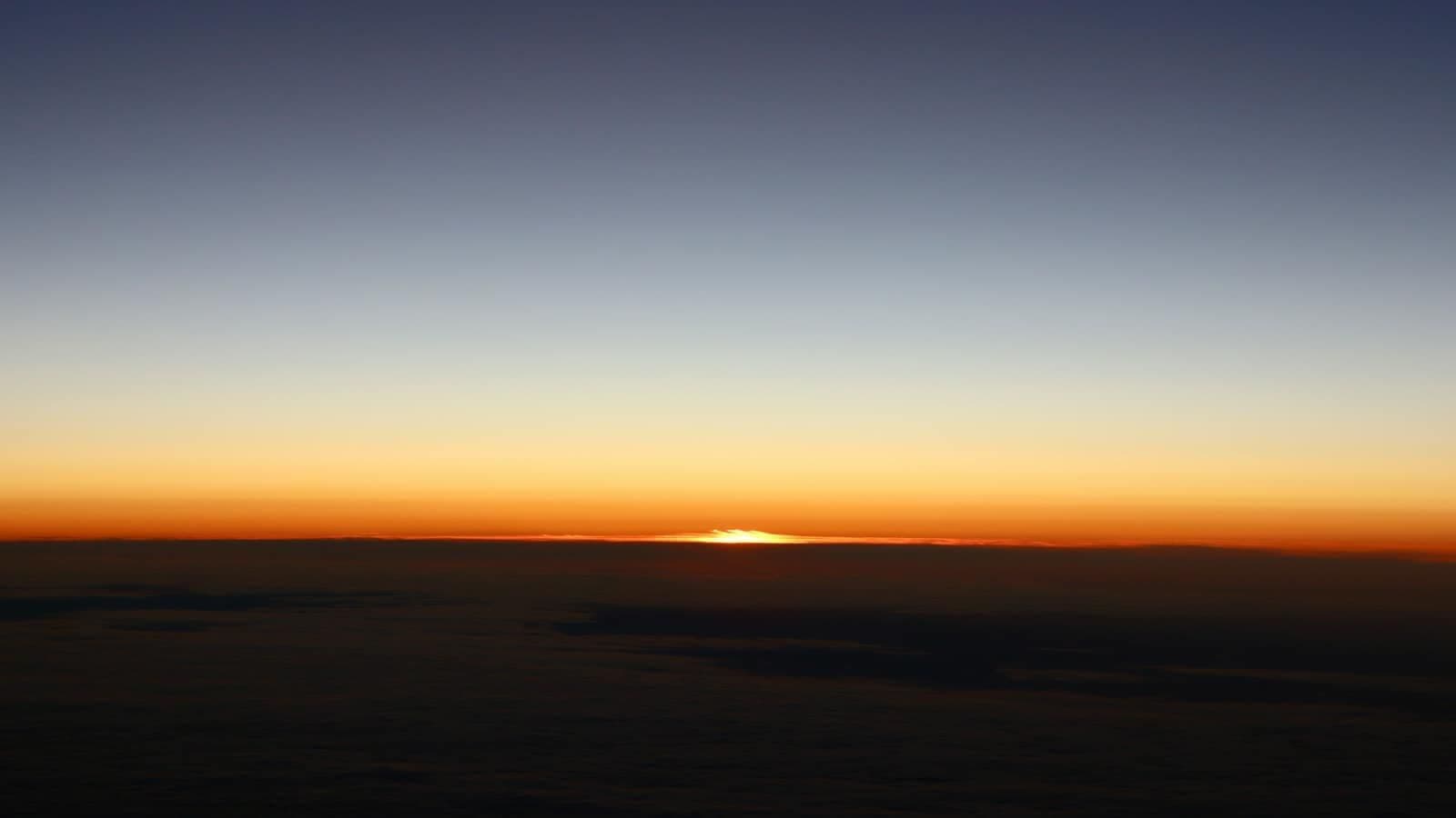 A sky at dawn above the clouds