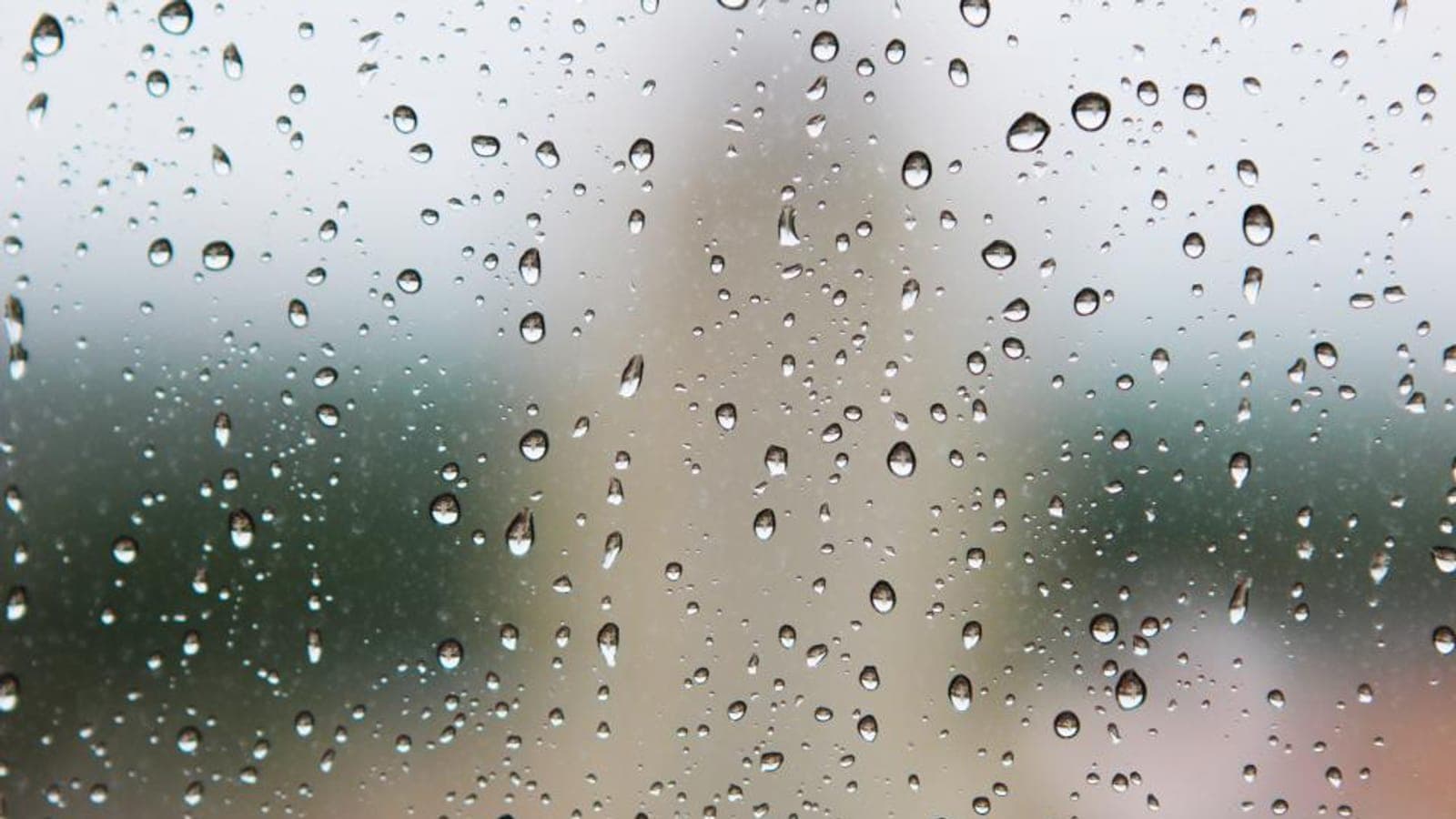 Raindrops running down a window pane