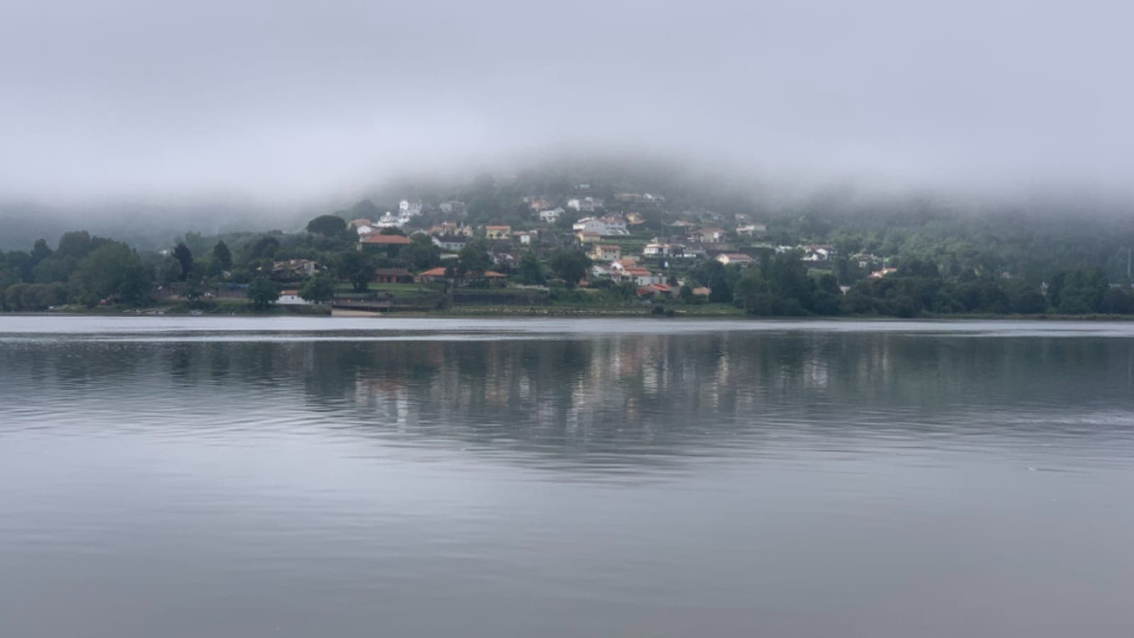 A still, misty lake at dawn