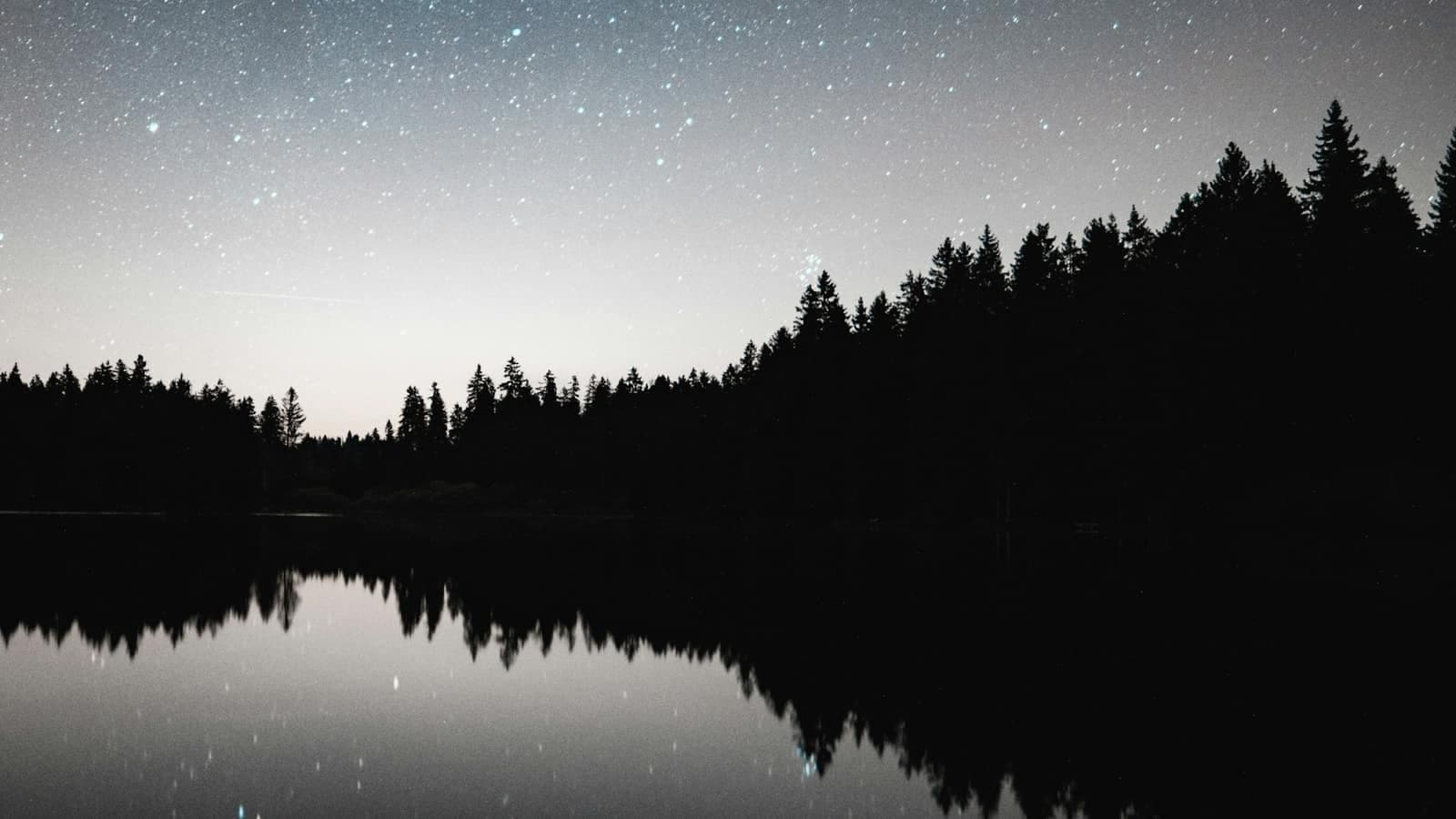 A calm night sky over a quiet horizon