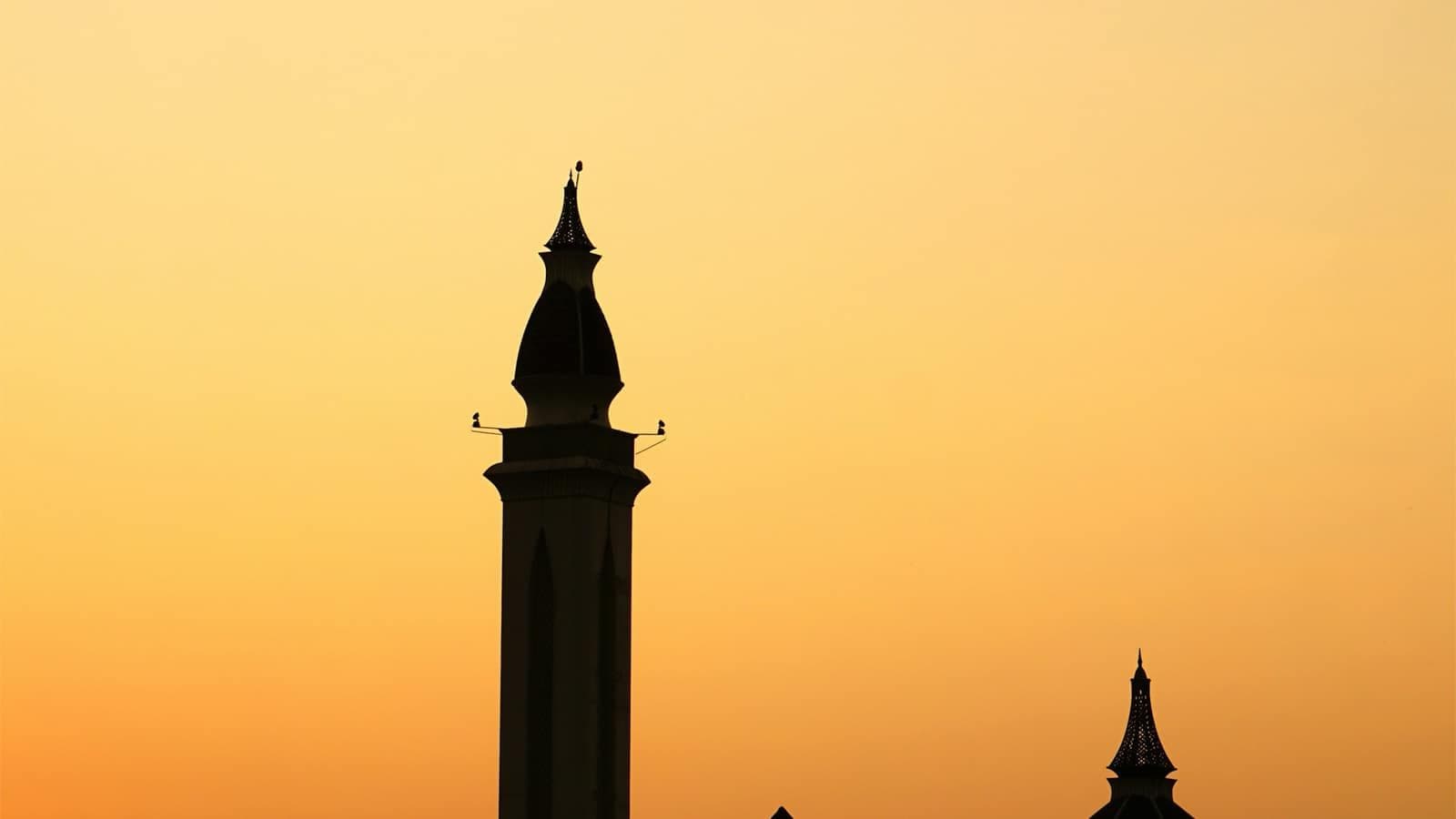 Silhouette of a mosque at golden hour