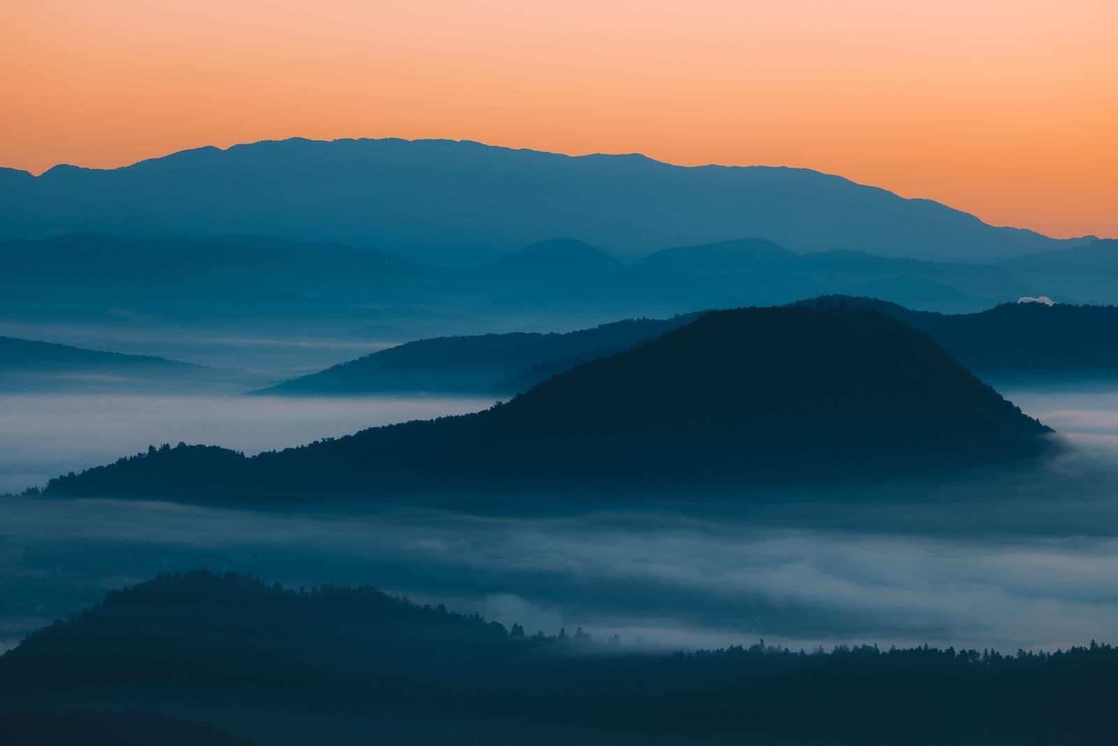 Misty mountains glowing at dawn