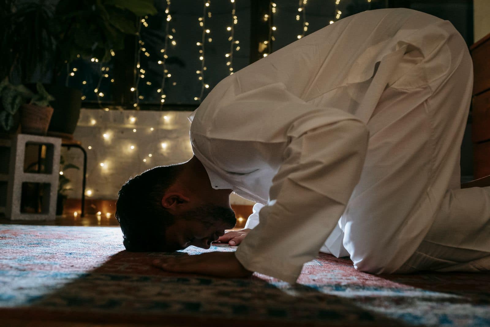 A believer in prostration on a prayer rug