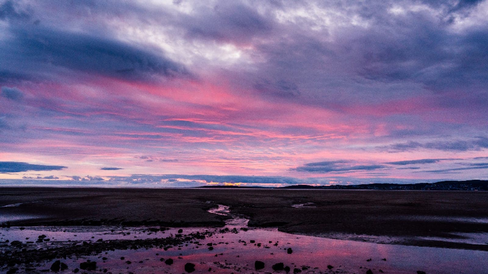 A pink and purple sunset over the water